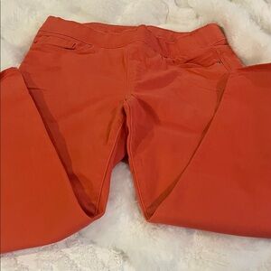 Women's coral stretch Levi jeans.